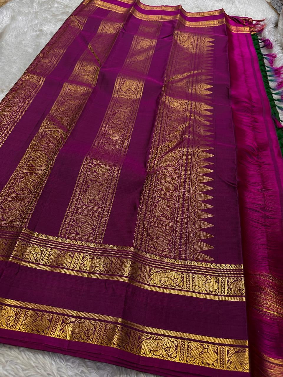 Magenta pallu spread with gold zari jaal panels and broad zari border with heritage detailing
