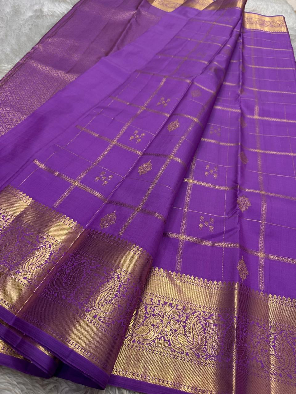 Nayaki ✨ — Lavender Pure Kanchipuram Silk Saree
With Zari Kattam Checks Across the Lustrous Body
Interspersed Floral Buttas in Gleaming Gold Zari
Majestic Peacock Motif Border in Heritage Weave
Grand Lavender Pallu with Rich Zari Brocade Artistry