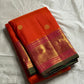 Kalpana  
Pure Silk Kanchipuram Saree  
Burnt Orange with Golden Buttas  
Intricate Magenta & Gold Zari Border