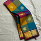 Rangoli Kattam – Pure Silk Kanchipuram Saree
Vibrant multicolor kattam checks with golden zari buttas across the body
Rich rani pink pallu with intricate zari weaving for a grand finish
Contrast purple borders edged with gleaming zari motifs