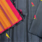 Close-up of orange striped pallu with black tassels beside black Pure Kanchipuram Silk Saree fabric with a yellow bird motif, shipped from New Jersey USA.