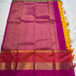 Varna Jaalam — Kanchipuram Pure Silk

Manjal yellow body with gold chakram buttas

Rani pink korvai border with floral & coin zari panels

Magenta–orange chevron pallu with blue–green color block top

Silk Mark Certified • Free Shipping within USA •