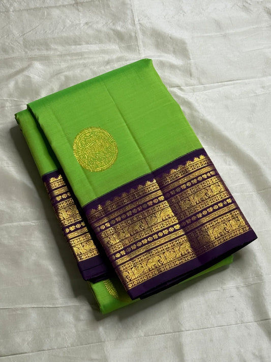 Arangetram — Parrot-Green Kanchipuram Pure Silk
Royal Purple Korvai Border 

Elephant Procession Panels & Coin Buttas

Rich Brocade Pallu • Blouse Included

Silk Mark Certified • Free USA Shipping • Ships in Two Weeks