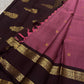Maroon body with gold buttas and contrast coffee pallu with zari woven border and tassels