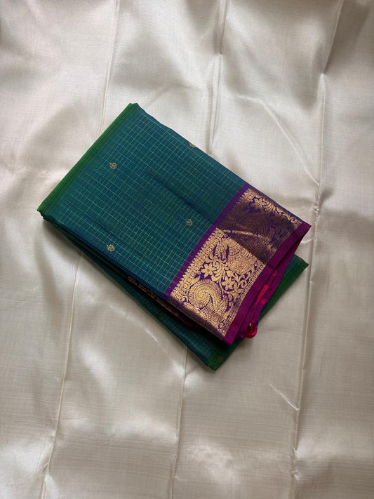 Vrindavan Meadow
Peacock Vairaoosi in Emerald & Lagoon Blue
Pure Kanchipuram Silk · Zari-Woven Border Grandeur