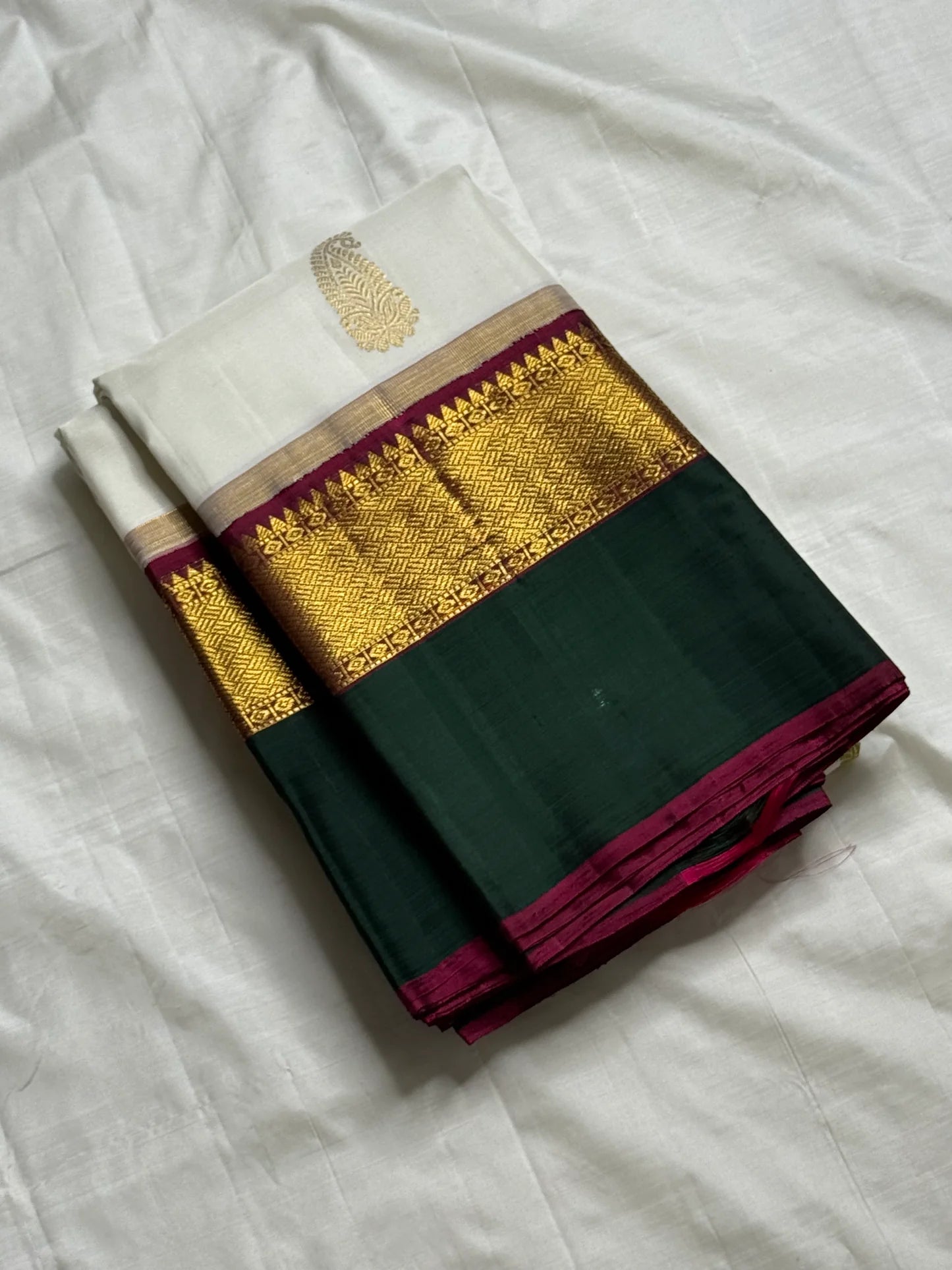 Ivory Malligai — Pure Silk Kanchipuram Saree
Ivory body with multi-color paisley buttas and gold zari diamond border
Arakku pallu with floral zari weave | Silk Mark Certified | Ships in Two Weeks | Free USA