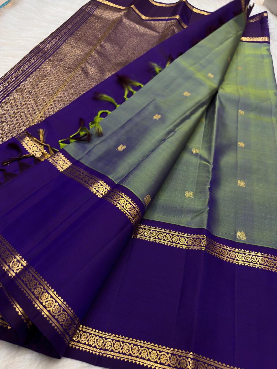 Peacock diamond lattice pallu on a green and violet Kancheepuram saree