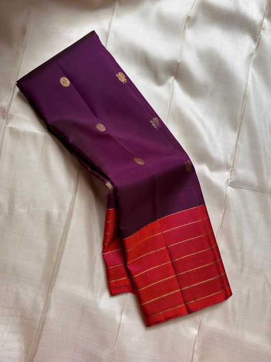 Poornima Kalyani
Deep Purple & Vermilion Kanchipuram Silk Saree
Zari Buttas · Checkered Borders · Silk Mark Certified