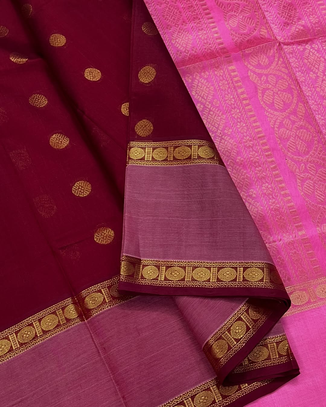 Cherry Red Silk Cotton Saree  
Raspberry Pink Rettapet Border  
Pavun Coin Butta All Over  
Grand Floral & Rudraksham Pallu
