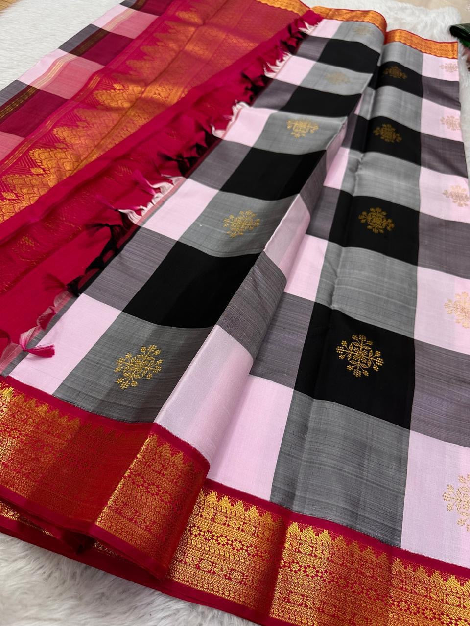 Charcoal Ash Blush Kattam
Pure Kanchipuram Silk Saree – Charcoal Grey, Black & Blush Pink Checks
Contrast deep red korvai borders with intricate gold zari temple motifs
Grand zari pallu, silk mark certified.ships in 2 weeks