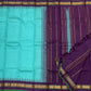 Gopura Neelam — Kanchipuram Pure Silk Saree

 

 

Teal-green body with micro kattam checks for a sleek drape

Regal aubergine korvai border with gopuram/temple motifs & gold zari

Parrot-green selvedge for a fresh, festive pop of contrast

Aubergine pall