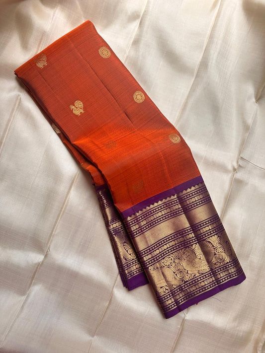 Pure silk kanchipuram serene terracotta  orange with purple border  mayil and kamalam butta on body and Pallu