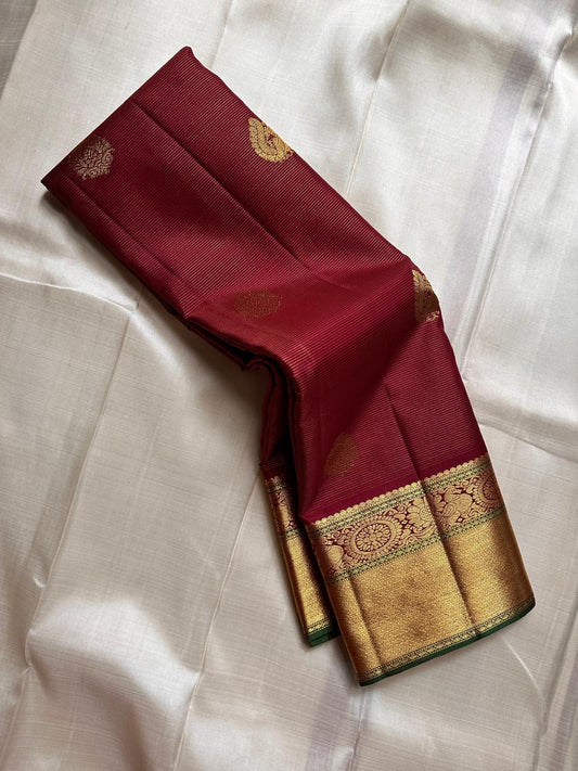 Burgundy Vairaoosi – Pure Kanchipuram Silk Saree
Classic burgundy body woven with Vairaoosi ✨
with delicate gold floral medallion buttas for temple elegance
antique-gold korvai borders with rosettes & chevron. Silk Mark Certified, delivery in 2 weeks