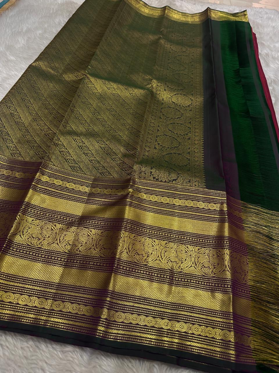 Red pure silk Kanchipuram with vertical zari stripes parrot motif varisaipet border with shot of green red Pallu