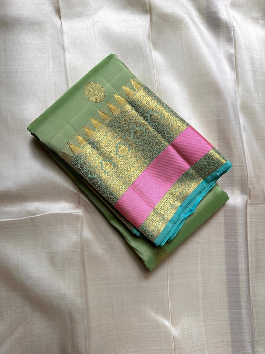Rose pistachio meadow  – Pure Silk Kanchipuram Saree
Pista Green Body with Coin Paving Mayil Zari Buttas 🦚
Borders in Aqua & Rose with Pillayar Moggu Motifs ✨
Grand Aqua Pallu in All-Over Zari Brocade Weave
Silk Mark Certified | ships in 2 weeks