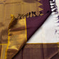 Pallu view of Kanchipuram silk saree in deep plum with dense antique-gold zari weaving and temple-inspired border