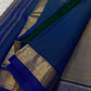Varnam – Dove Tail Gray & Peacock Blue Kanchipuram Silk Saree. Featuring rich gold paisley buttas, a bold chevron zari border, and pure handloom silk craftsmanship ✨ Silk Mark Certified | Blouse Stitching Available | Free USA Shipping