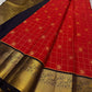 Ranga - A vivid red pure silk Kanchipuram saree featuring intricate zari kattam with traditional mayil, chakram, butta, and vanasringaram motifs across the body. The contrast jamun dark blue border and pallu are woven with exquisite Annam motifs
