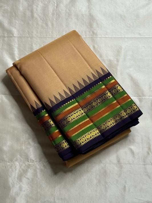 Sandal Temple – Pure Silk Kanchipuram Saree
Sandal Body with mild sheen , pillayar moggu   ✨
Indigo-Purple Korvai Border with Green & Ochre Stripes
Temple Gopuram Zari Edging & Grand Brocade Pallu
Silk Mark Certified | ships in two weeks