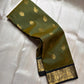 Olive Pachai – Pure Korvai Kanchipuram Silk Saree
Olive green body with gold zari gaja & medallion buttas
Contrast black korvai border with peacock & floral vines
Grand brocade pallu with lattice & temple patterns
Silk Mark Certified …chk description