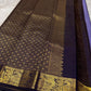 Classic heritage finesse in this lilac blue pure Kanchipuram silk saree Zari kattam , intricately handwoven with fine golden checks across the body. Scattered floral buttas add delicate charm,rich purple peacock border