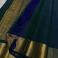 Close view of zari woven border detailing in antique gold with teal silk body and contrast blue pallu edge