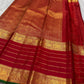 Kiran – Deep Red Kanchipuram Pure Silk Saree
Zari Checks with Delicate Buttas and Striped Rettapet Border
Richly Woven Pallu Accented by a bottle Green Selvedge