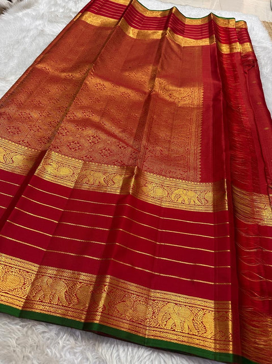 Kiran – Deep Red Kanchipuram Pure Silk Saree
Zari Checks with Delicate Buttas and Striped Rettapet Border
Richly Woven Pallu Accented by a bottle Green Selvedge