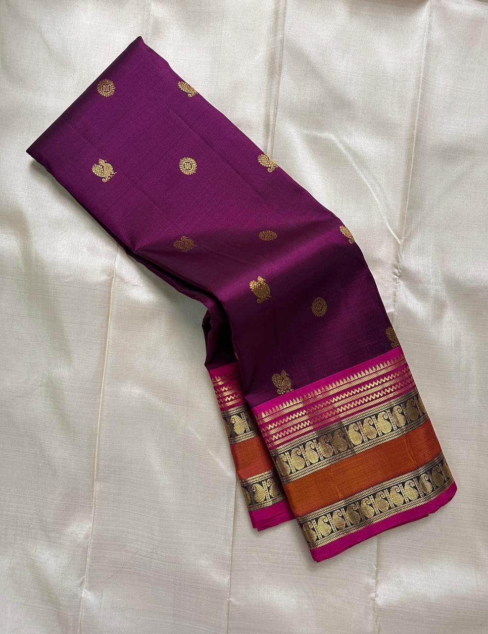 Kavyashree Plum Lustre — Pure Kanchipuram Silk Saree
Deep Plum Body with Gold Buttas, Rust–Magenta Korvai Borders
Silk Mark Certified | Free Shipping within USA | Ships in Two Weeks