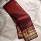 Gilded Rust – Pure Kanchipuram Silk Saree
Deep rust body with delicate paisley zari buttas 🌿
Antique-gold border featuring kaddi stripes & floral motifs ✨
Grand brocade pallu with lattice jaal & floral vines 🕊️

Silk Mark Certified, delivery in 2 weeks
