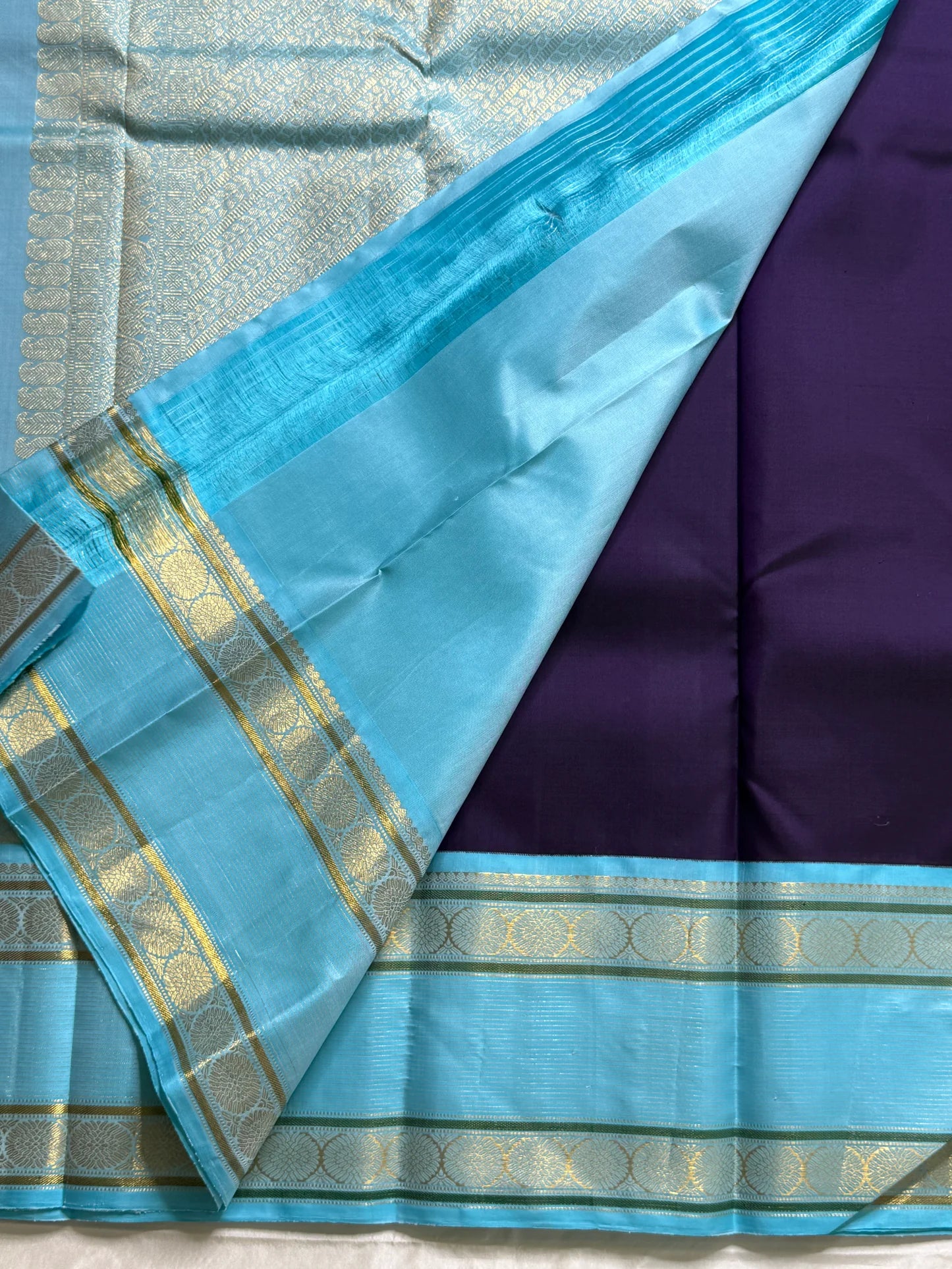 Moora – Handwoven Pure Kanchipuram Silk Saree in Deep Regal Purple with Lustrous Contrast Aqua Blue Border and Grand Pallu, Featuring Intricate Gold Zari Weaving with Traditional Round Medallions, Paisley Buttas, and Concentric Floral Vine Patterns