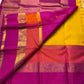 Varna Jaalam — Kanchipuram Pure Silk

Manjal yellow body with gold chakram buttas

Rani pink korvai border with floral & coin zari panels

Magenta–orange chevron pallu with blue–green color block top

Silk Mark Certified • Free Shipping within USA •