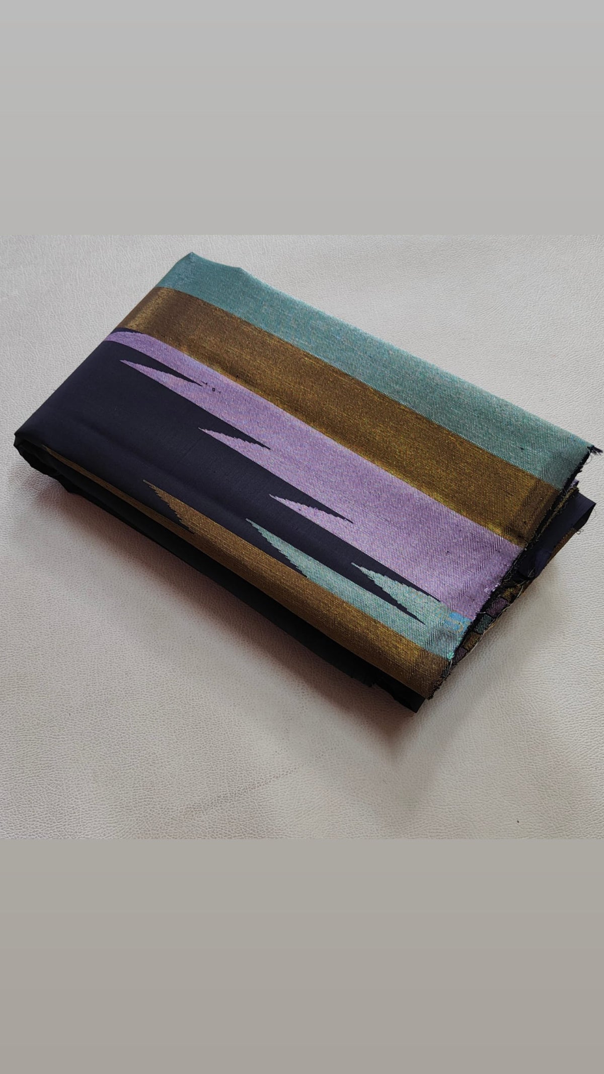 Deep charcoal-black Kanchipuram silk in a traditional Ettukol weave with delicately contrasting pastel threads.