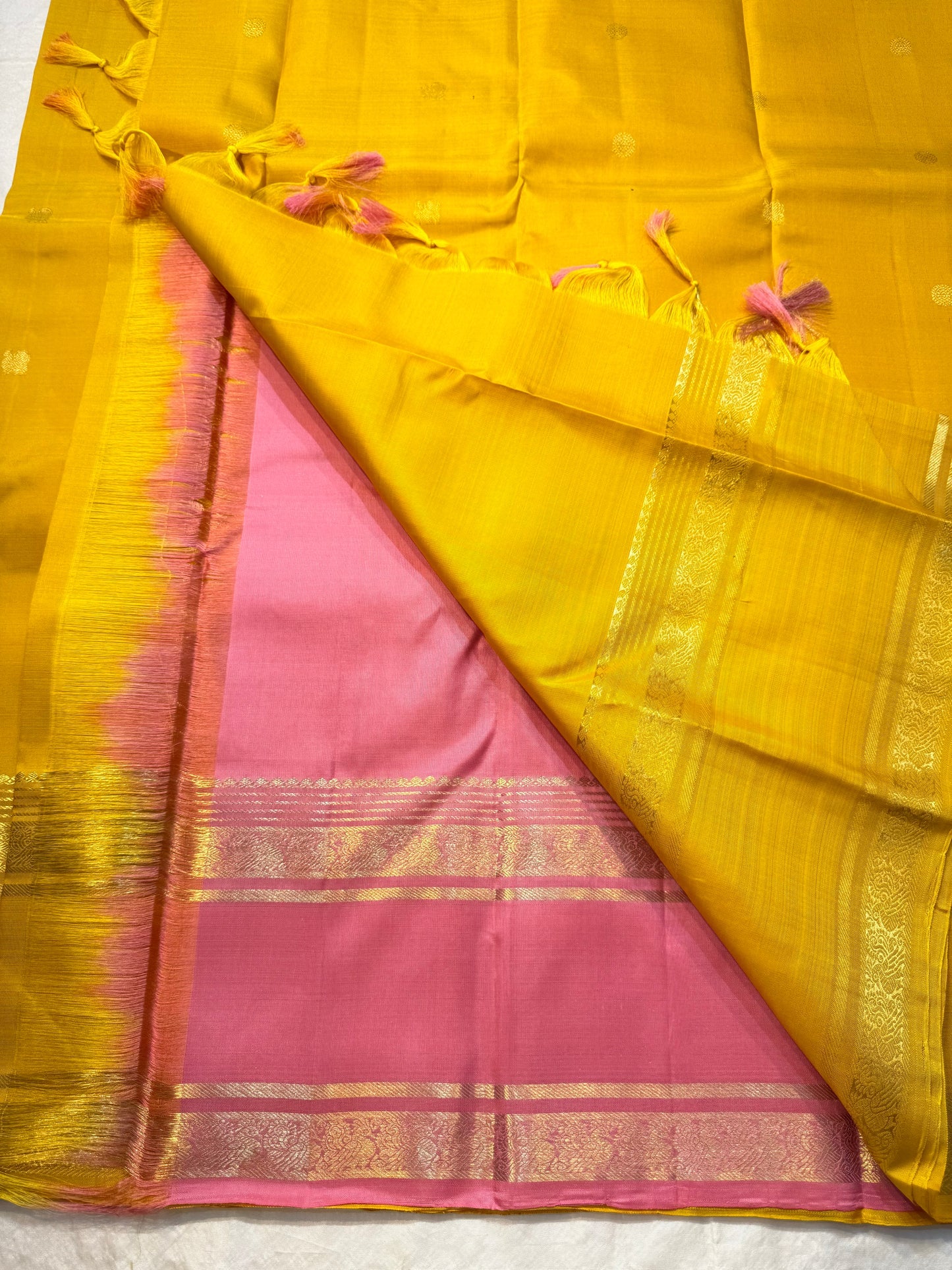 Kanakam mellow yellow body with zari rosette buttas and antique-gold borders; intricate pallu in diamond brocade with tassels.rose pink blouse 
Silk Mark Certified • Free Shipping within USA • Ships in Two Weeks ✅