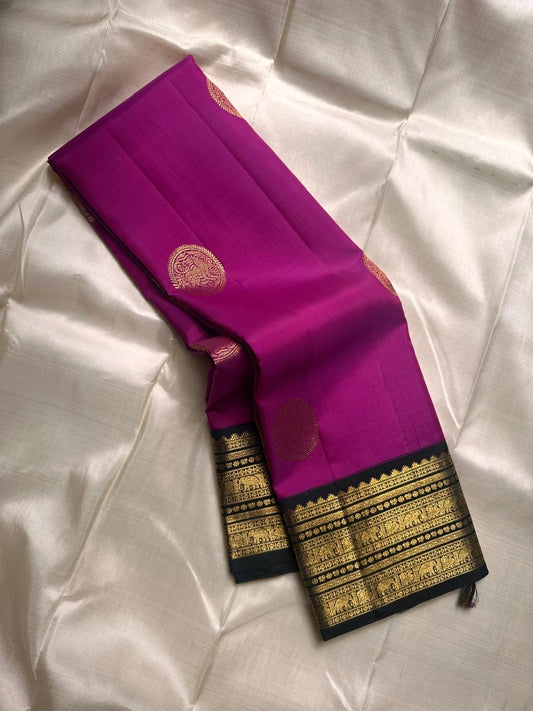 Menaka ✨ Draped in vibrant purple , its body shines with golden Yazhi motifs enshrined in Sorgavaasal arches. The contrasting black Korvai border, alive with elephants, vines, and temple motifs in zari and lavish Pallu , silk mark certified ❤️
