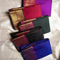 Amethyst Zari Kattam – Pure Kanchipuram Silk Saree
Rich Amethyst Purple Body with Golden Zari Checks
Broad Gold Zari Border with Red Highlights & Temple Motifs
Radiant Ruby Red-Orange Pallu with Lustrous Zari Stripes

Silk Mark Certified, delivery in 2 we