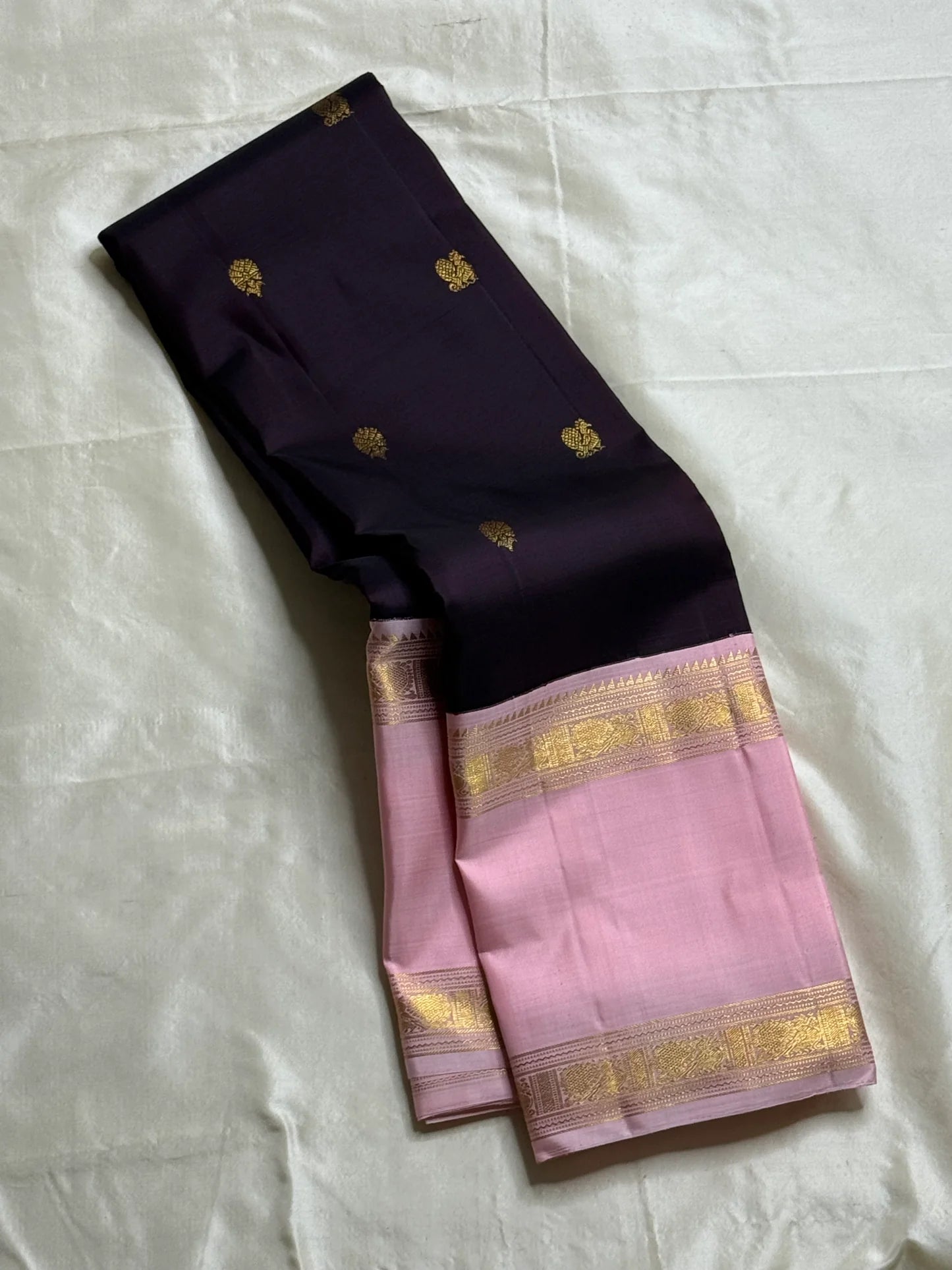 Rose Twilight – Pure Kanchipuram Silk Saree
Pastel Rose-Pink border with Golden Zari Weaves
Deep Plum-Violet Base Scattered with Gold Buttas
French Rose Rettapet Border in Lustrous Zari

Silk Mark Certified, delivery in 2 weeks