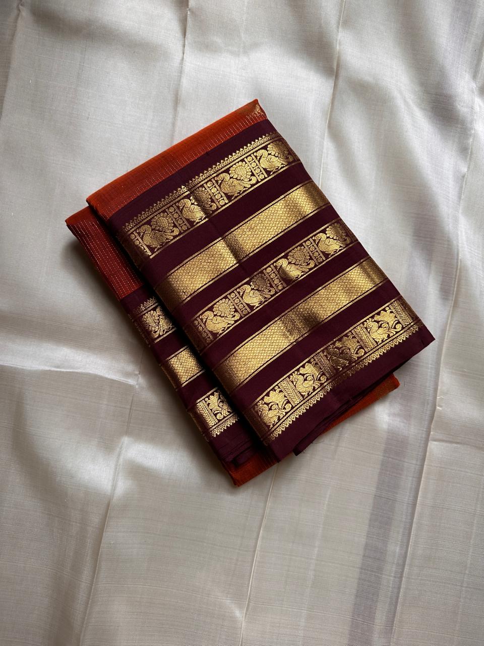 Ember Yazhi – Pure Kanchipuram Silk Saree
Burnt Orange Body with Vaira Oosi Stripes & Yazhi Buttas
Contrast Maroon Varisaipet Border with Gold Zari Panels
Grand Maroon Brocade Pallu with Intricate Motifs

Silk Mark Certified, delivery in 2 weeks