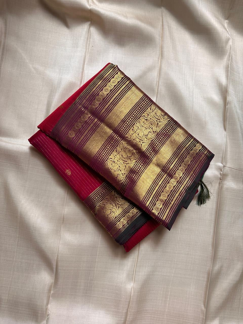 Red pure silk Kanchipuram with vertical zari stripes parrot motif varisaipet border with shot of green red Pallu