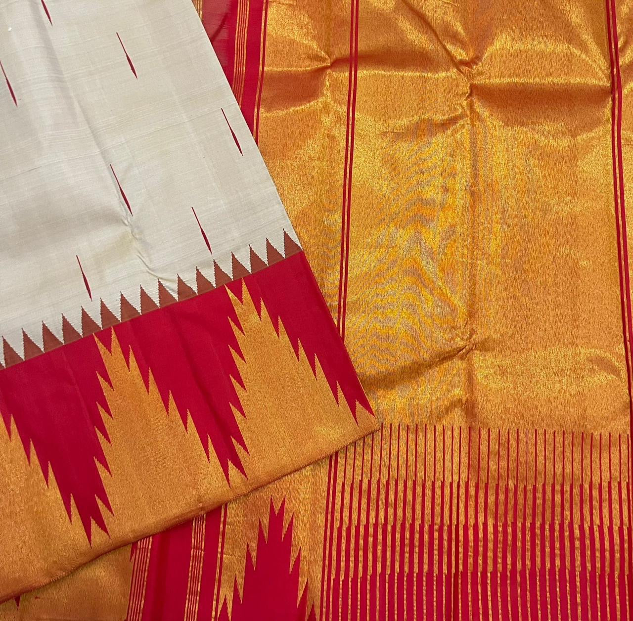 Vermillion Venpattu Ettukol — Pure Kanchipuram Silk 
Ivory venpattu body with fine red temple -motifs in ettukol weaving 

Vermilion-red &gold korvai temple (reku) borders

Mullai moggu woven motifs on body  

Silk Mark Certified | Free Shipping within US