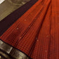 Terracotta Temple – Pure Kanchipuram Silk Saree
Brick red body with fine zari grid checks & golden buttas ✨
Deep coffee-maroon borders and grand diamond-jaal pallu in antique gold.