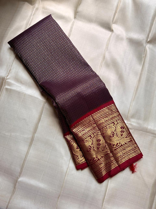 Pure silk kanchipuram deep coffee with zari motifs and bright red border