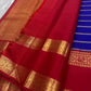 Meera – A Living Raga in Kanchipuram Silk: Draped in Crimson and Iconic MS Blue, Adorned with Gold Zari Seer, Muthu Borders, and Peacocks and kamalam , Woven in the Spirit of Classical Grace and Devotion
