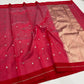 Close view of rose pink handloom Chanderi silk with small metallic leaf buttas and contrasting green accents