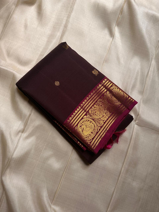 deep coffee brown silk stirred gently with a bold magenta border-  rich drape pure silk mayil chakram butta saree