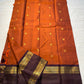 🧡 

Swarnamala — Korvai Kanchipuram Pure Silk

Rust-orange body with radiant gold chakram buttas

Deep purple korvai borders with rich zari detailing

Striped zari brocade pallu with temple-inspired motifs

Silk Mark Certified • Free Shipping within USA