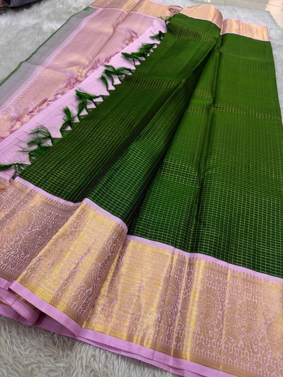 Vibrant green Zari kattam with pastel pink border peacock motif and Pallu