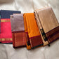 🌼 Marigold Kungumam Annam — Korvai Kanchipuram Pure Silk

Sun-marigold body with tiny mango buttas ✨

Kungumam maroon korvai borders with majestic Annam (peacock) panels

Rich maroon brocade pallu with diamond jaal & kaddi bands

Silk Mark Certified |