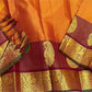 Ushas — Rust Orange Pure Kanchipuram Silk Saree
Radiant Rust Orange Oosi Kattam body with ornate Paisley 2gm Zari ✨
Arakku Red Vanasringaram, Muthuseer & Kamalam border with Fishpettu 
Exquisite Arakku Red diamond-pet grid Zari pallu green selvedge