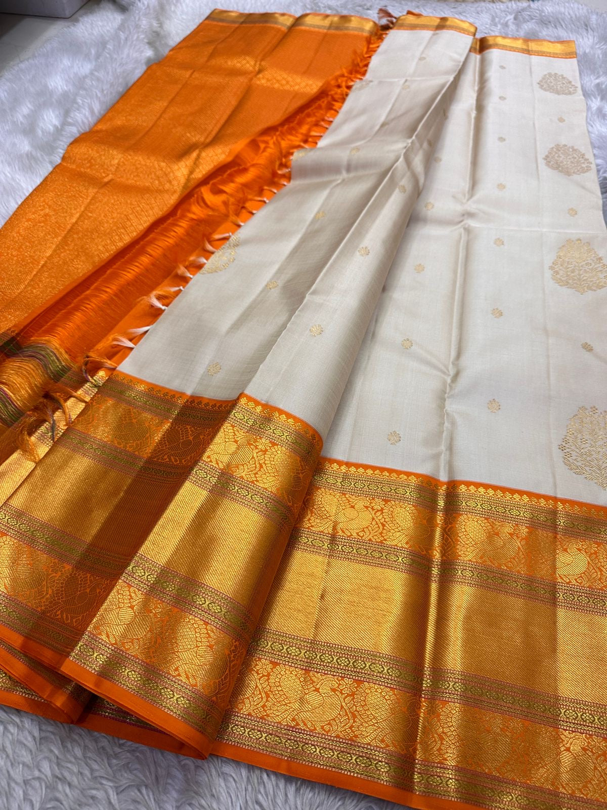 Champa Venpattu — Pure Kanchipuram Handloom Silk Saree
Ivory Champa Body • Marigold-Orange Zari Borders
Heirloom Silk · Temple-Ready Elegance